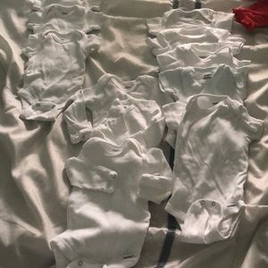 11 brand new Gerber white onesies.